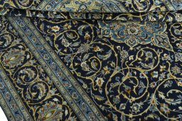 Close-up detail of 2000s Kashan rug from Iran / Persia showing Wool weave