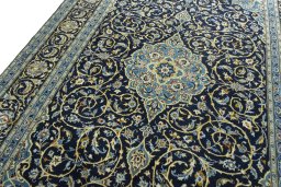Backside of handmade 2000s Kashan rug showing knot structure and weave density