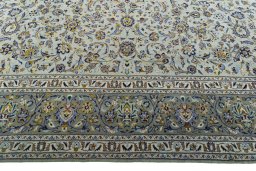 Corner detail of 2000s Kashan rug showing border pattern and Wool pile