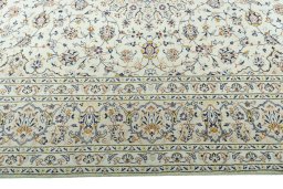 Corner detail of 2000s Kashan rug showing border pattern and Wool pile