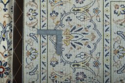 Backside of handmade 2000s Kashan rug showing knot structure and weave density
