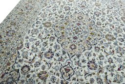 Backside of handmade 2000s Kashan rug showing knot structure and weave density