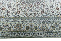 Corner detail of 2000s Kashan rug showing border pattern and Wool pile