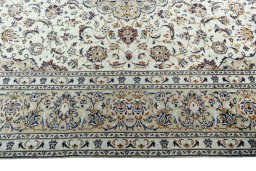 Corner detail of 2000s Kashan rug showing border pattern and Wool pile