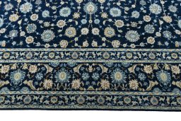 Corner detail of 2000s Kashan rug showing border pattern and Wool pile
