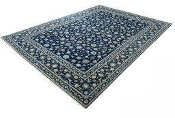Corner detail of 2000s Kashan rug showing border pattern and Wool pile