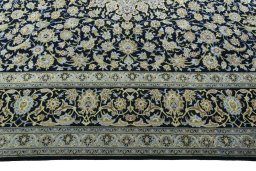 Corner detail of 2000s Kashan rug showing border pattern and Wool pile