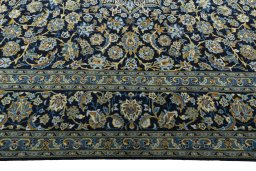 Corner detail of 2000s Kashan rug showing border pattern and Wool pile