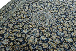 Backside of handmade 2000s Kashan rug showing knot structure and weave density