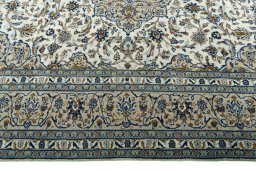 Corner detail of 2000s Kashan rug showing border pattern and Wool pile