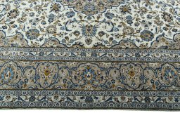 Corner detail of 2000s Kashan rug showing border pattern and Wool pile