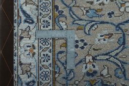 Backside of handmade 2000s Kashan rug showing knot structure and weave density