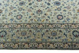 Corner detail of 2000s Kashan rug showing border pattern and Wool pile