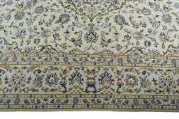 Corner detail of 2000s Kashan rug showing border pattern and Wool pile