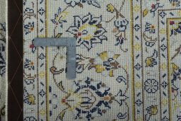 Backside of handmade 2000s Kashan rug showing knot structure and weave density