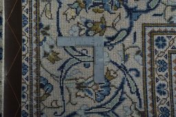 Backside of handmade 2000s Kashan rug showing knot structure and weave density