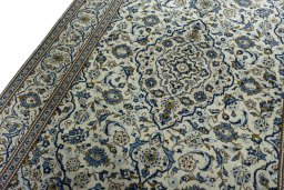 Backside of handmade 2000s Kashan rug showing knot structure and weave density