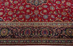 Corner detail of 2000s Kashan rug showing border pattern and Wool pile