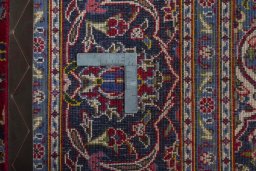 Backside of handmade 2000s Kashan rug showing knot structure and weave density