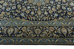 Corner detail of 2000s Kashan rug showing border pattern and Wool pile