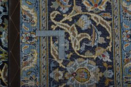 Backside of handmade 2000s Kashan rug showing knot structure and weave density