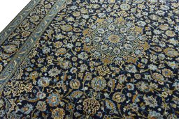 Backside of handmade 2000s Kashan rug showing knot structure and weave density