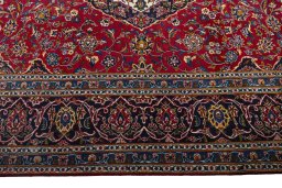 Corner detail of 2000s Kashan rug showing border pattern and Wool pile