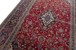 Backside of handmade 2000s Kashan rug showing knot structure and weave density