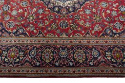 Corner detail of 2000s Kashan rug showing border pattern and Wool pile
