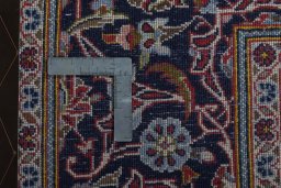 Backside of handmade 2000s Kashan rug showing knot structure and weave density