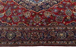 Corner detail of 2000s Kashan rug showing border pattern and Wool pile