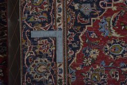 Backside of handmade 2000s Kashan rug showing knot structure and weave density