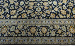 Corner detail of 2000s Kashan rug showing border pattern and Wool pile