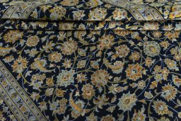 Close-up detail of 2000s Kashan rug from Iran / Persia showing Wool weave