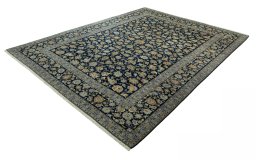 Corner detail of 2000s Kashan rug showing border pattern and Wool pile