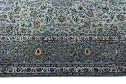 Corner detail of 2000s Kashan rug showing border pattern and Wool pile