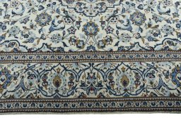 Corner detail of 2000s Kashan rug showing border pattern and Wool pile