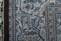 Backside of handmade 2000s Kashan rug showing knot structure and weave density