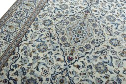 Backside of handmade 2000s Kashan rug showing knot structure and weave density