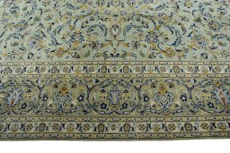 Corner detail of 2000s Kashan rug showing border pattern and Wool pile