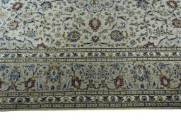 Corner detail of 2000s Kashan rug showing border pattern and Wool pile