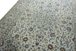 Backside of handmade 2000s Kashan rug showing knot structure and weave density