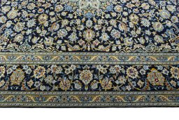Corner detail of 2000s Kashan rug showing border pattern and Wool pile