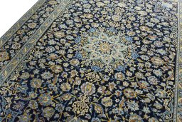 Backside of handmade 2000s Kashan rug showing knot structure and weave density