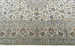 Corner detail of 2000s Kashan rug showing border pattern and Wool pile