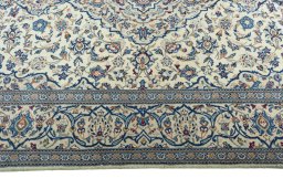 Corner detail of 2000s Kashan rug showing border pattern and Wool pile