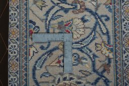 Backside of handmade 2000s Kashan rug showing knot structure and weave density