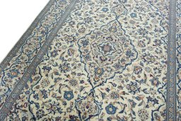 Backside of handmade 2000s Kashan rug showing knot structure and weave density