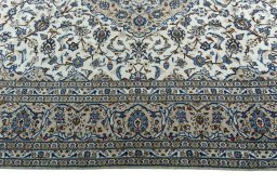 Corner detail of 2000s Kashan rug showing border pattern and Wool pile