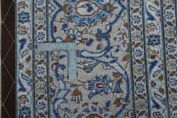 Backside of handmade 2000s Kashan rug showing knot structure and weave density